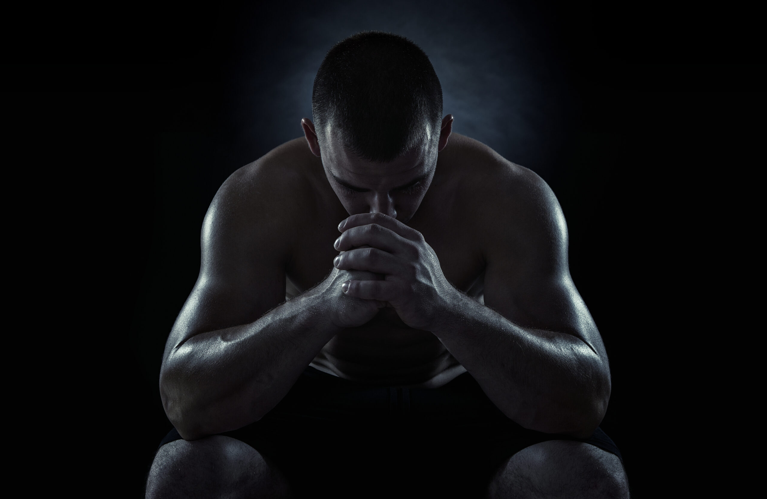 Close up of young sportsman focusing before the game isolated on black background